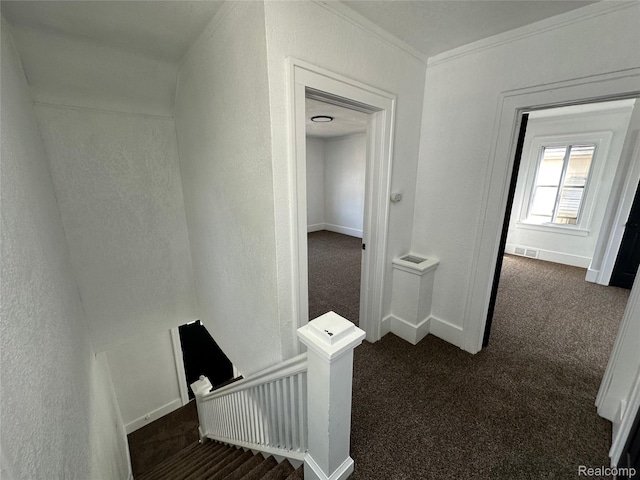 4222 High St, Ecorse, MI 48229 - hallway featuring dark carpet, a textured wall, crown molding, and an upstairs landing