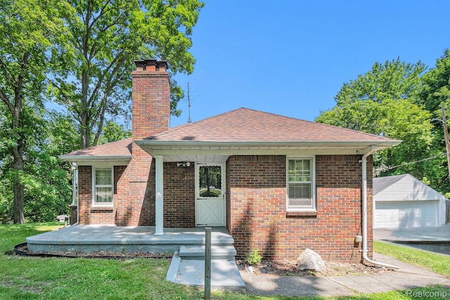 3382 W Silver Lake Rd, Fenton, MI 48430 - view of front facade with a chimney, brick siding, roof with shingles, and a front lawn
