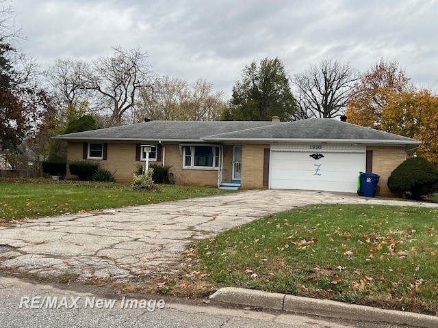 1910 Weiss St, Saginaw, MI 48602 - ranch-style house featuring concrete driveway, a garage, brick siding, and a front lawn