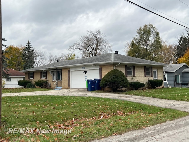1910 Weiss St, Saginaw, MI 48602 - single story home with driveway, a garage, brick siding, and a front yard