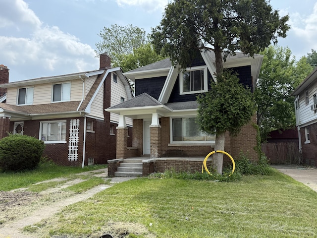2427 Highland St, Detroit, MI 48206 - view of front of house with a shingled roof, a chimney, and brick siding