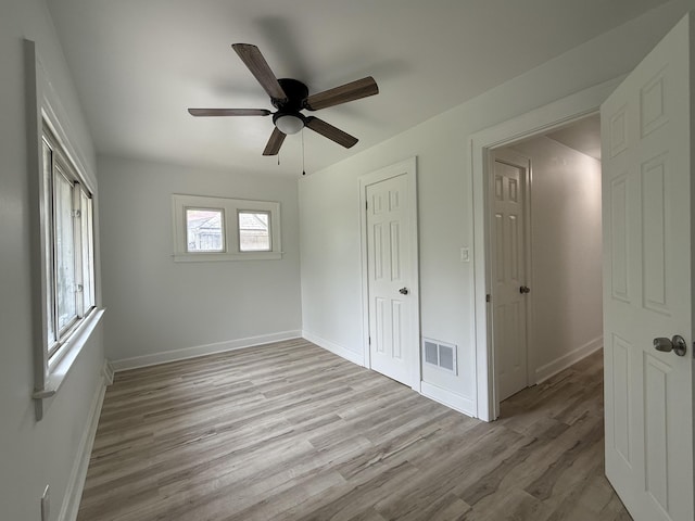 2427 Highland St, Detroit, MI 48206 - unfurnished bedroom featuring wood finished floors, a ceiling fan, and a closet