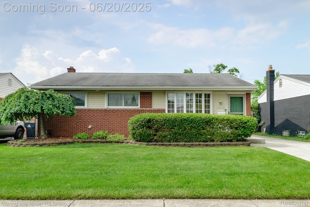 30635 Cooley Blvd, Westland, MI 48185 - view of front of property featuring brick siding, a front lawn, and a chimney