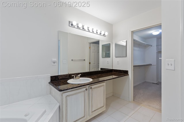 7382 Gateway Dr, West Bloomfield, MI 48322 - bathroom with vanity, a garden tub, a walk in closet, and tile patterned floors