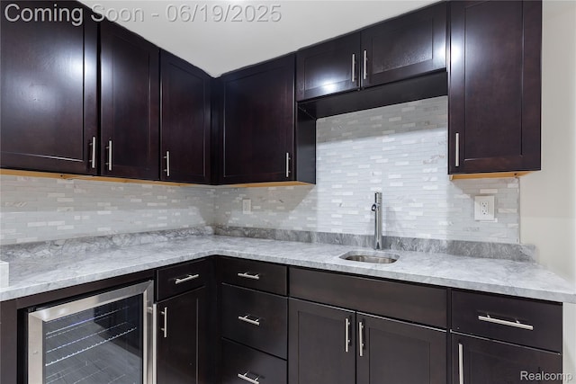 7382 Gateway Dr, West Bloomfield, MI 48322 - kitchen with beverage cooler, tasteful backsplash, dark brown cabinetry, and light stone countertops