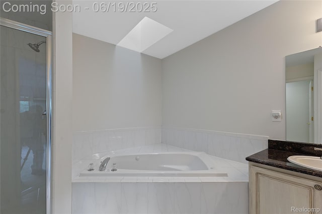 7382 Gateway Dr, West Bloomfield, MI 48322 - bathroom with a skylight, vanity, a bath, and a shower stall