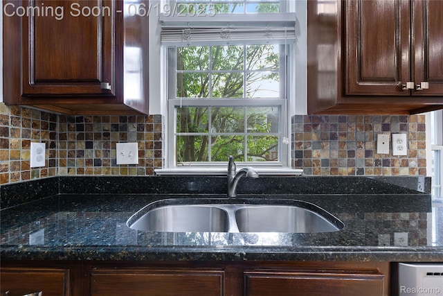 7382 Gateway Dr, West Bloomfield, MI 48322 - kitchen with dark stone counters, dark brown cabinetry, and tasteful backsplash