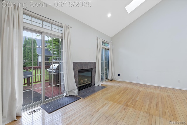 7382 Gateway Dr, West Bloomfield, MI 48322 - unfurnished living room featuring hardwood / wood-style flooring, high vaulted ceiling, plenty of natural light, a skylight, and recessed lighting