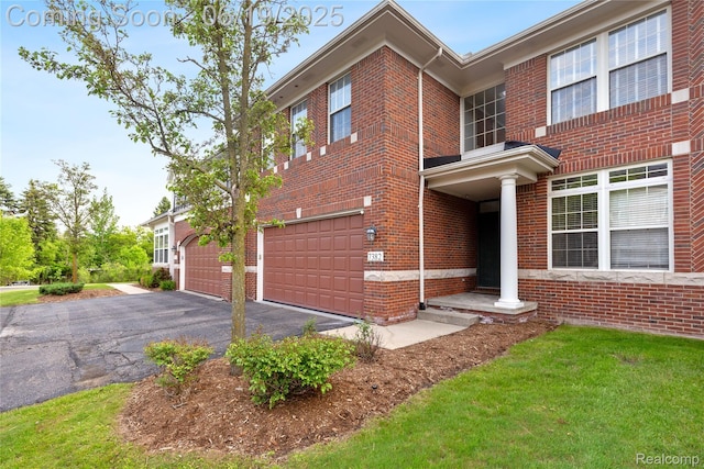 7382 Gateway Dr, West Bloomfield, MI 48322 - view of front facade with brick siding, an attached garage, and asphalt driveway