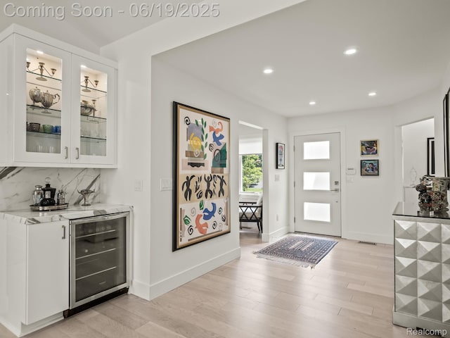 6420 Apple Grove Ln, Bloomfield Hills, MI 48301 - entryway featuring wine cooler, recessed lighting, light wood-style flooring, and bar