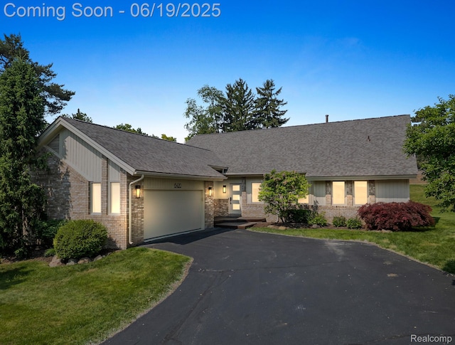 6420 Apple Grove Ln, Bloomfield Hills, MI 48301 - view of front of property featuring brick siding, a garage, driveway, a front yard, and a shingled roof