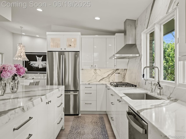 6420 Apple Grove Ln, Bloomfield Hills, MI 48301 - kitchen with wall chimney range hood, stainless steel appliances, white cabinetry, plenty of natural light, and recessed lighting