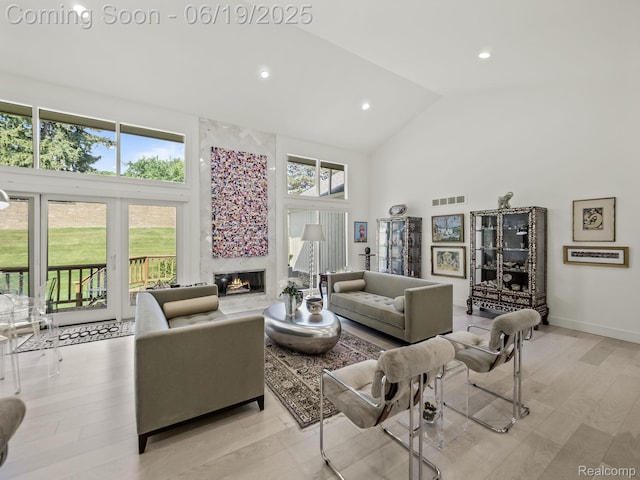 6420 Apple Grove Ln, Bloomfield Hills, MI 48301 - living area with high vaulted ceiling, healthy amount of natural light, a premium fireplace, light wood-type flooring, and recessed lighting