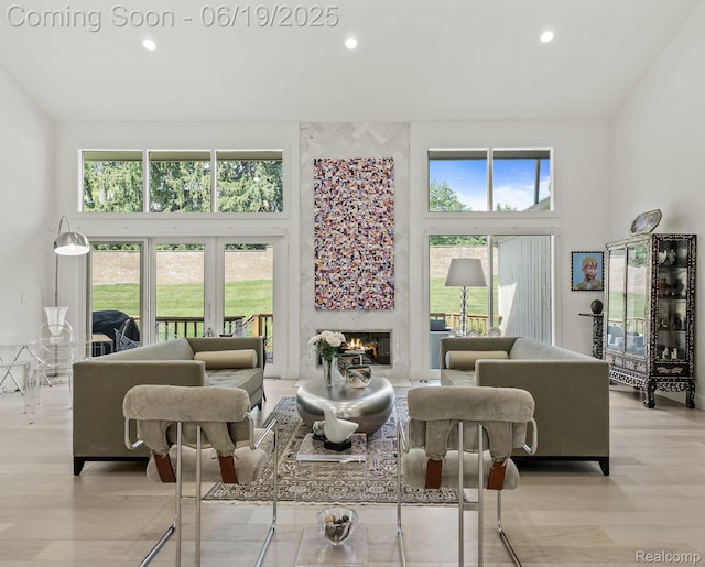 6420 Apple Grove Ln, Bloomfield Hills, MI 48301 - living room featuring a towering ceiling, a high end fireplace, recessed lighting, and light wood-style floors