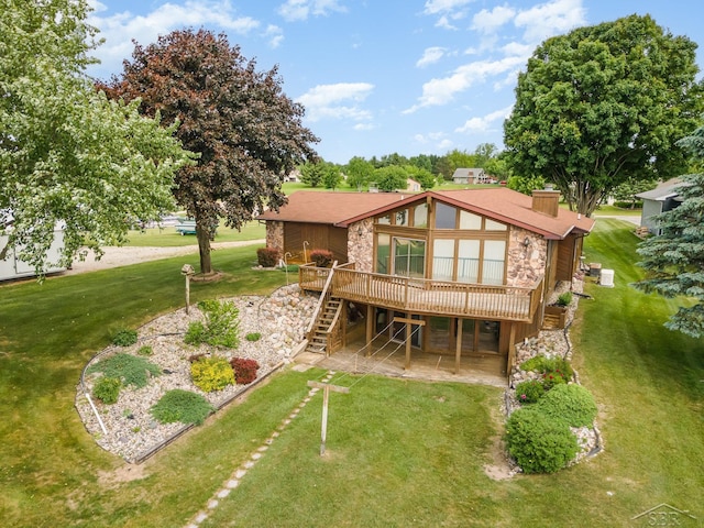 1653 Manchester Way, Gladwin, MI 48624 - rear view of property with stone siding, a deck, stairs, and a patio