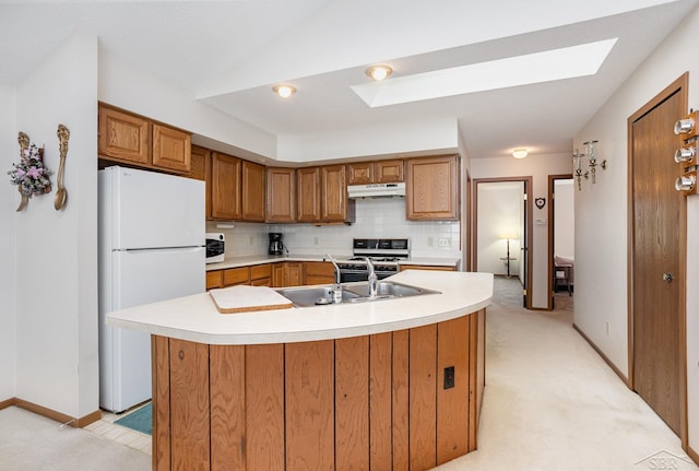 1653 Manchester Way, Gladwin, MI 48624 - kitchen featuring white appliances, under cabinet range hood, a skylight, light countertops, and vaulted ceiling
