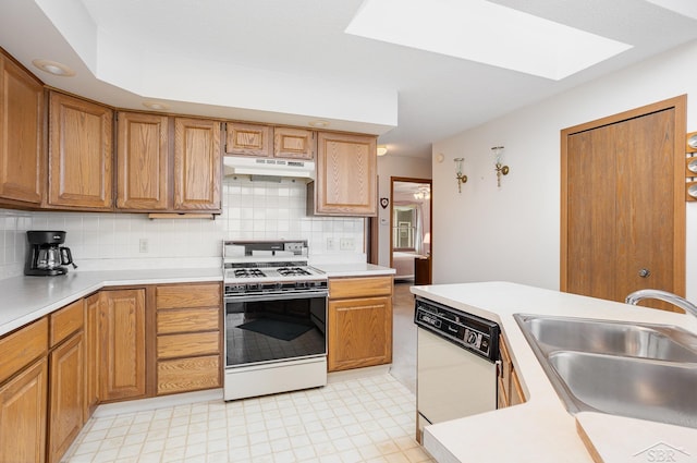 1653 Manchester Way, Gladwin, MI 48624 - kitchen with white appliances, under cabinet range hood, a skylight, backsplash, and light countertops