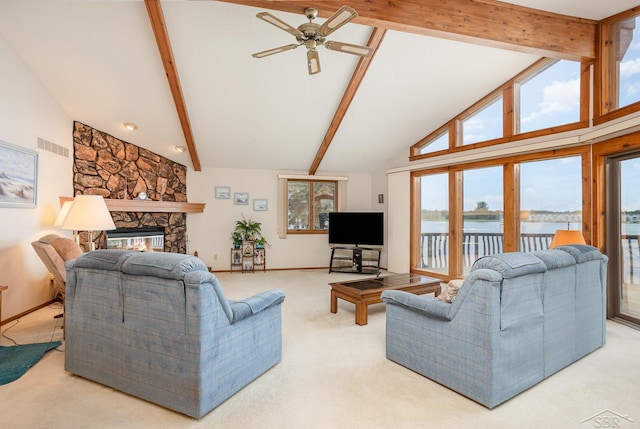 1653 Manchester Way, Gladwin, MI 48624 - living area featuring beamed ceiling, carpet floors, a ceiling fan, a fireplace, and high vaulted ceiling
