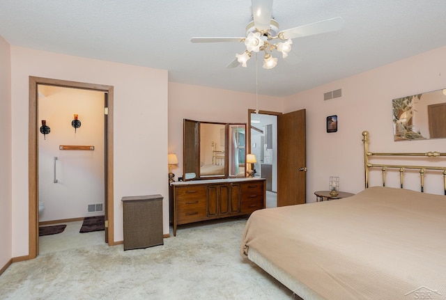 1653 Manchester Way, Gladwin, MI 48624 - bedroom featuring light colored carpet, ensuite bath, and ceiling fan