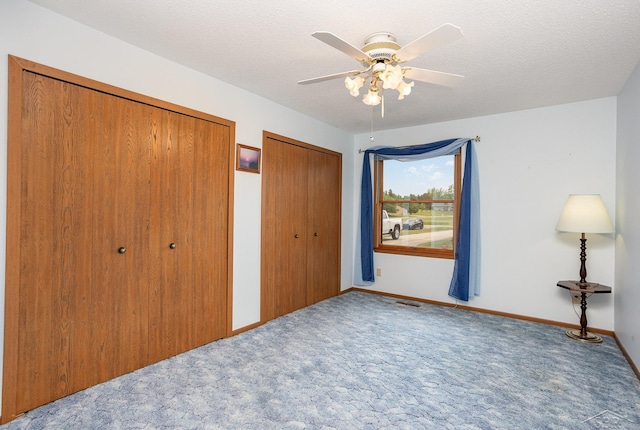 1653 Manchester Way, Gladwin, MI 48624 - unfurnished bedroom featuring two closets, carpet flooring, and ceiling fan