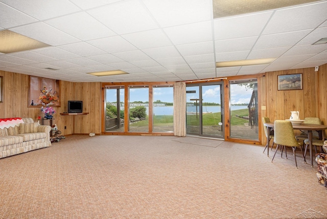 1653 Manchester Way, Gladwin, MI 48624 - living room with wooden walls, carpet, and a drop ceiling