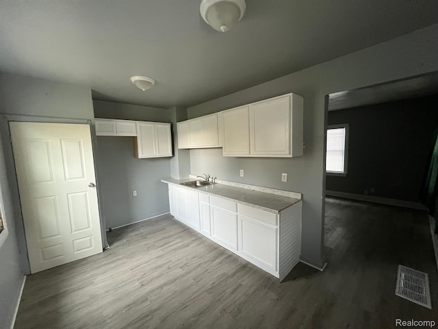 13763 Sparling St, Hamtramck, MI 48212 - kitchen featuring wood finished floors and white cabinetry