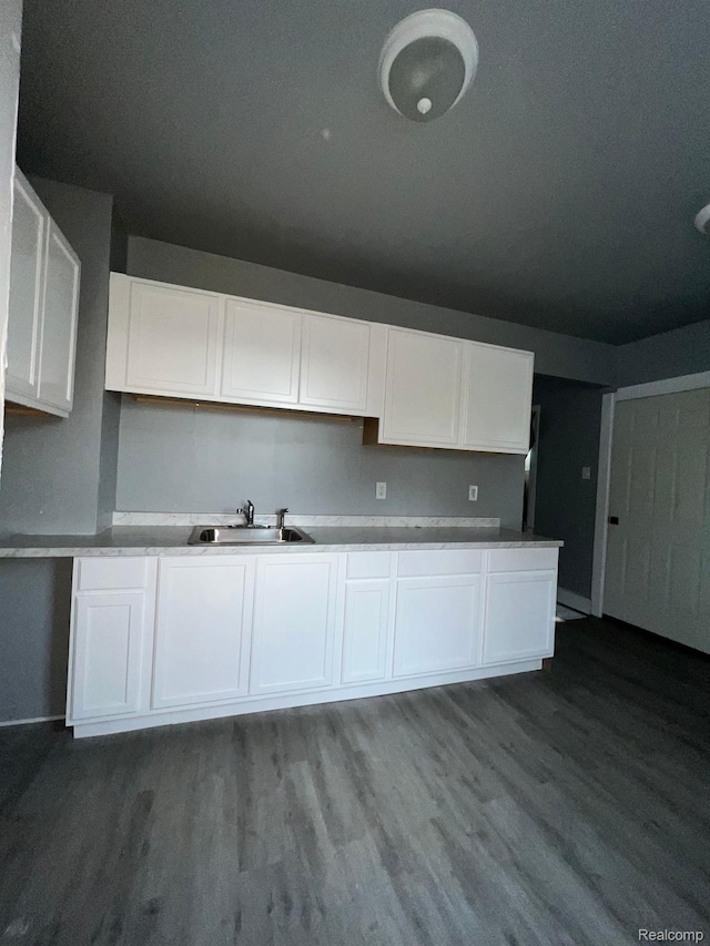 13763 Sparling St, Hamtramck, MI 48212 - kitchen featuring white cabinetry and dark wood finished floors