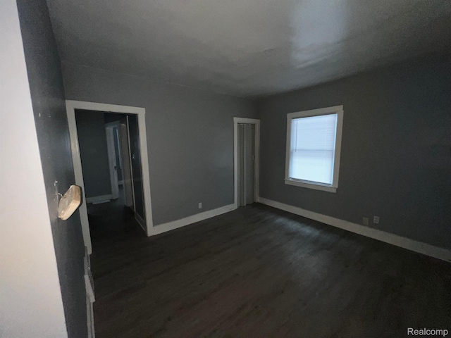 13763 Sparling St, Hamtramck, MI 48212 - empty room featuring dark wood-type flooring and baseboards