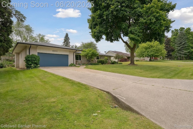 8077 Casa Mia Dr, White Lake, MI 48386 - view of front of property with a garage, brick siding, a front lawn, and concrete driveway