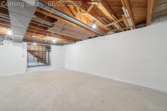 8077 Casa Mia Dr, White Lake, MI 48386 - basement featuring stairs and concrete block wall