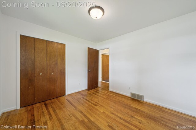8077 Casa Mia Dr, White Lake, MI 48386 - unfurnished bedroom featuring a closet and wood finished floors