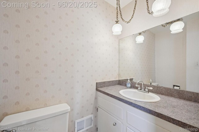 8077 Casa Mia Dr, White Lake, MI 48386 - half bathroom with wallpapered walls and vanity