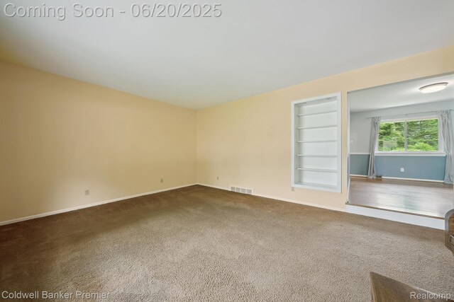 8077 Casa Mia Dr, White Lake, MI 48386 - unfurnished room with built in shelves and carpet floors