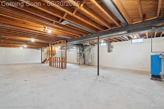 8077 Casa Mia Dr, White Lake, MI 48386 - below grade area with gas water heater, heating unit, stairs, and a water pressure tank