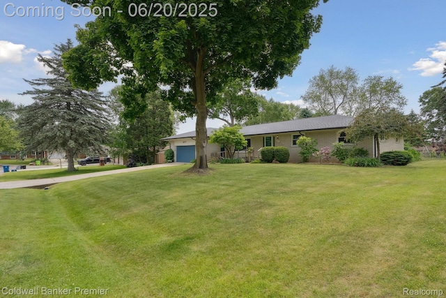 8077 Casa Mia Dr, White Lake, MI 48386 - view of front facade featuring concrete driveway, an attached garage, a front lawn, and brick siding