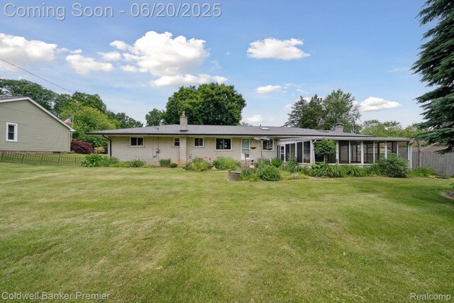 8077 Casa Mia Dr, White Lake, MI 48386 - back of property with a chimney, a sunroom, and brick siding