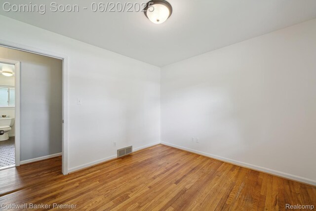 8077 Casa Mia Dr, White Lake, MI 48386 - empty room with wood finished floors and baseboards
