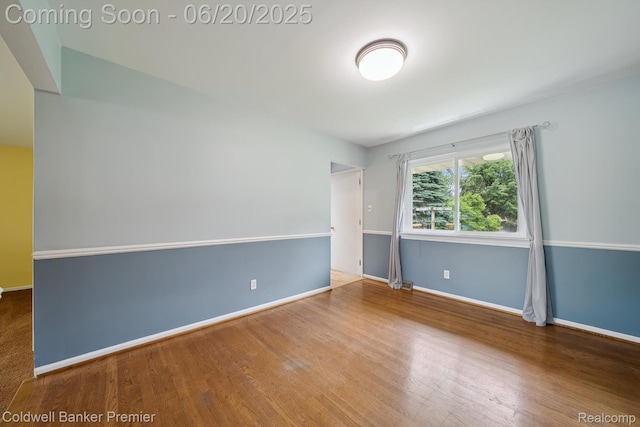 8077 Casa Mia Dr, White Lake, MI 48386 - unfurnished room featuring baseboards and wood finished floors