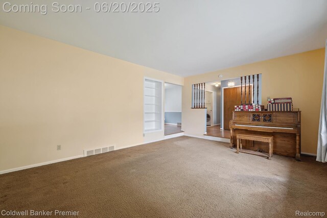 8077 Casa Mia Dr, White Lake, MI 48386 - carpeted living room featuring built in shelves and a chandelier