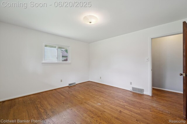 8077 Casa Mia Dr, White Lake, MI 48386 - unfurnished room featuring wood finished floors and baseboards