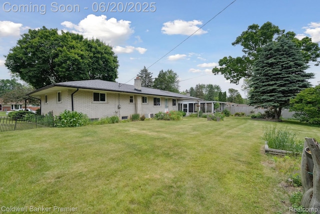 8077 Casa Mia Dr, White Lake, MI 48386 - rear view of house with brick siding and a chimney