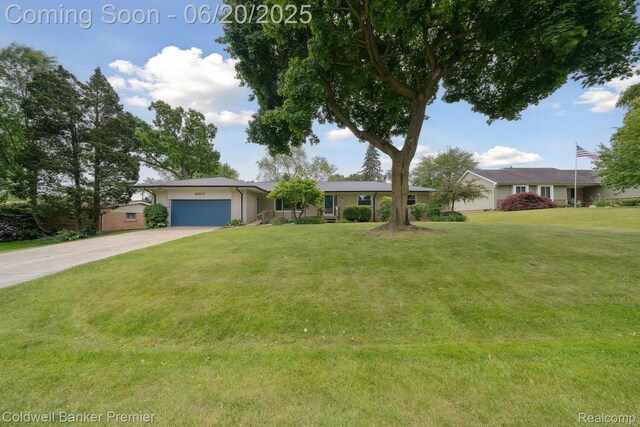 8077 Casa Mia Dr, White Lake, MI 48386 - ranch-style house with a garage, concrete driveway, and a front lawn