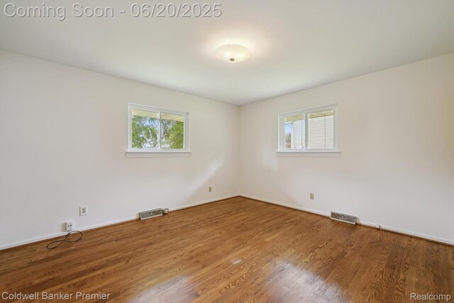 8077 Casa Mia Dr, White Lake, MI 48386 - unfurnished room featuring plenty of natural light and wood finished floors