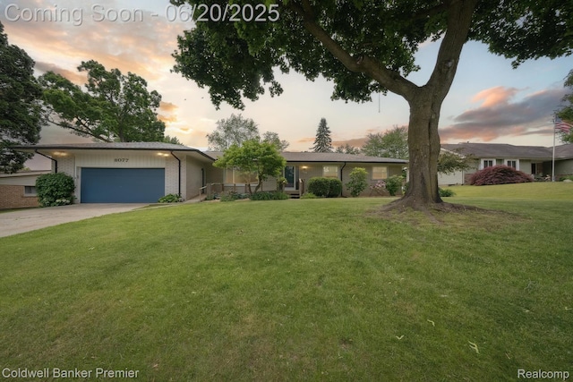 8077 Casa Mia Dr, White Lake, MI 48386 - view of front of property featuring an attached garage, a lawn, concrete driveway, and brick siding