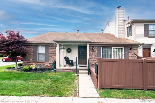 41195 Southwind Dr, Canton, MI 48188 - view of front facade with brick siding, a chimney, and a shingled roof