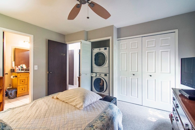41195 Southwind Dr, Canton, MI 48188 - bedroom featuring stacked washer / drying machine, a closet, a ceiling fan, and ensuite bath