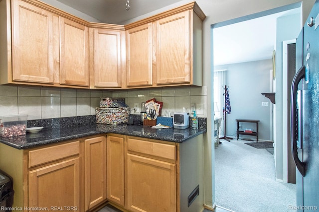 41195 Southwind Dr, Canton, MI 48188 - kitchen featuring tasteful backsplash, freestanding refrigerator, light carpet, dark stone countertops, and light brown cabinetry