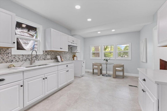 18419 Faust Ave, Detroit, MI 48219 - kitchen with backsplash, light countertops, recessed lighting, white cabinets, and light tile patterned floors