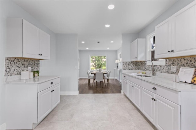 18419 Faust Ave, Detroit, MI 48219 - kitchen featuring light countertops, white cabinets, backsplash, and recessed lighting