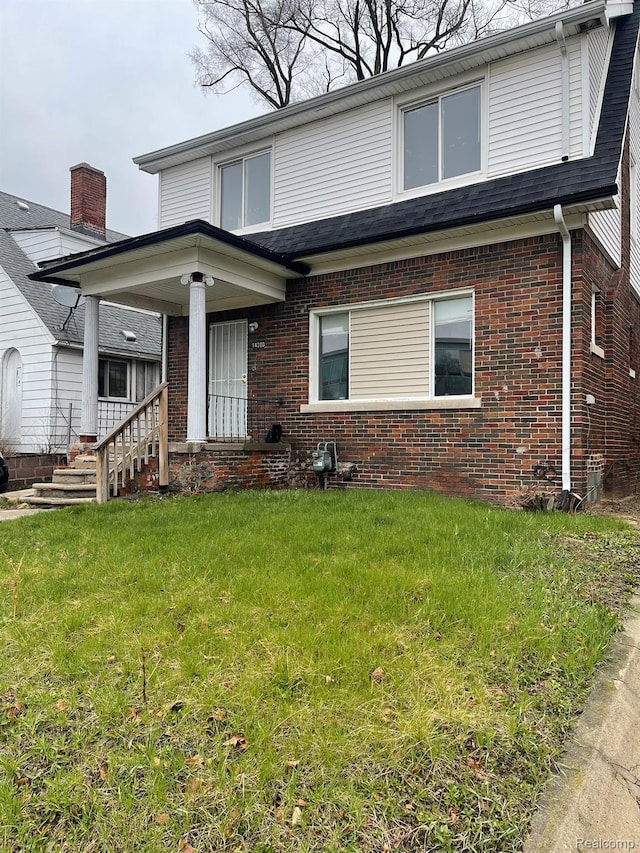 14200 Whitcomb St, Detroit, MI 48227 - view of front of house featuring brick siding, a front yard, and a porch
